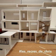 a doll house with all the windows and doors open on top of a hard wood floor