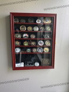 a wall mounted display case filled with lots of coins