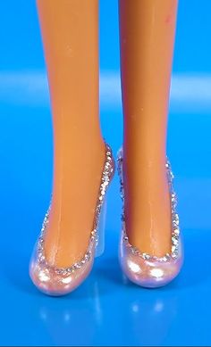 a doll's legs and shoes are shown with glitter on the bottom part of them