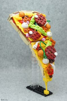 a slice of lego pizza with toppings on it