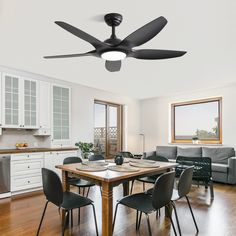 a dining room table with four chairs and a ceiling fan in the middle of it