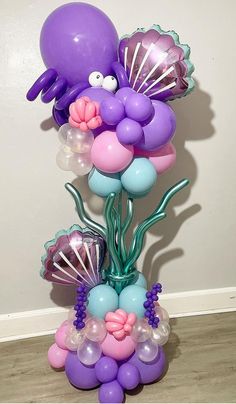 the balloon bouquet is made up of balloons and other items, including an octopus - like creature