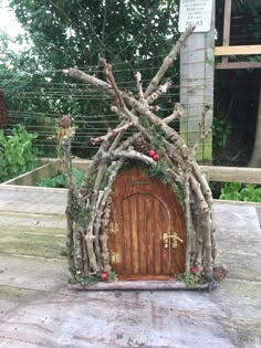 a wooden door made out of branches on top of a table