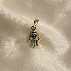 14K Yellow Gold Evil Eye Hamsa Charm Pendant, Protective Necklace, Hand of God Jewelry, Hamsa Hand Pendant ✅ PENDANT SPECIFICATIONS:  * Double Sided / 3D * Height: 0.43 in. (11 MM) * Width: 0.35 in. (9 MM) * Average Weight: 0.45 gr. * Type: Evil Eye/Evil Eye ✅ PREMIUM 14K GOLD:  Our jewelry is crafted from durable high quality materials, gems, and stones; hand-stamped for authenticity as well as FTC law approved. Unlike cheap costume jewelry, our long lasting jewelry is easy to polish and and wo God Jewelry, Evil Eye Hamsa, Hand Pendant, Hand Of God, Hamsa Charm, Gold Pendant Jewelry, Average Weight, Hamsa Hand, Jewelry Pouch