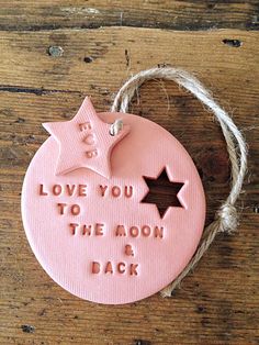 a pink ornament that says, love you to the moon and back