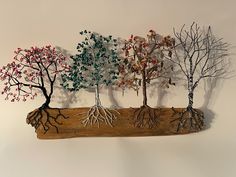 a group of trees that are on top of a piece of wood