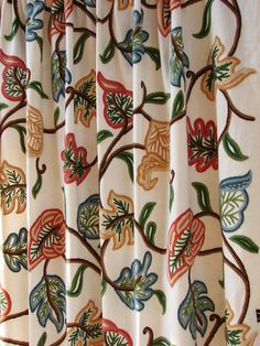 the curtain is decorated with colorful flowers and leaves