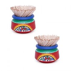 two colorful pots with toothpicks in them