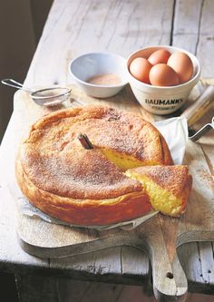 a table topped with a pie and bowls of eggs