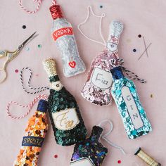 some bottles and scissors on a table with confetti