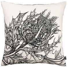 a black and white drawing of a thistle flower on a pillow cover with an embroidered border