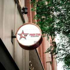 a sign hanging from the side of a building that says proud star international on it