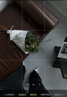 a person standing next to a brown bag with flowers on it and an object in the background