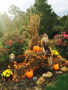 an old country home decorated for halloween with scarecrows and pumpkins