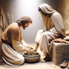 two statues of jesus and mary washing their hands in a bowl with water on the ground