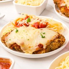 several plates of food on a table with pasta and sauces