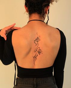 a woman with a tattoo on her back