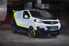 a white van with yellow accents parked in a garage