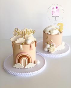 two cakes decorated with pink and gold frosting