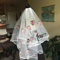 a wedding veil with pictures of the bride and groom's faces attached to it