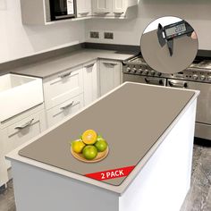 a kitchen island with two apples and lemons on it