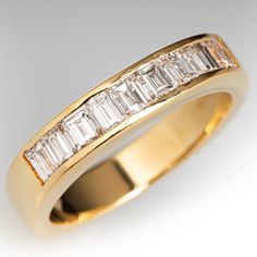 a yellow gold ring with baguetts of diamonds