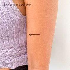 a woman's arm with a small tattoo on the left side of her arm