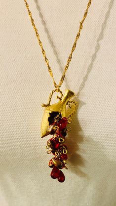 "Ancient Egyptian pitcher of life pendant with delicate red and gold Czech tear drop accents.  Pendant measures 1.25\" long on a 24\" 18k gold plated chain. Chain is 2mm thick. Eye catching, statement making and one of a kind.  Make this necklace your new favorite today!" Luxury Red Amulet Style Jewelry, Gold Teardrop Pendant Jewelry For Valentine's Day, Hand Forged Gold Teardrop Pendant Necklaces, Gold Wire Wrapped Jewelry For Festive Occasions, Festive Gold Wire Wrapped Jewelry, Unique Gold Jewelry For Valentine's Day, Brass Pendant Drop Necklace As A Gift, Hand Forged Red Jewelry For Gifts, Gold Teardrop Hand Forged Necklace