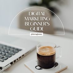 a cup of coffee sitting on top of a white table next to a laptop computer