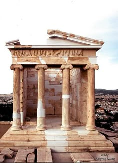 an old building with columns and pillars on top