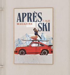 a magazine cover with a woman standing on top of a red car in the snow