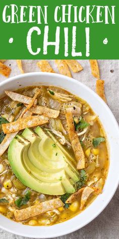 a white bowl filled with chicken tortilla soup and topped with an avocado