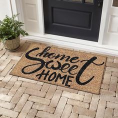 a welcome mat with the words home sweet home on it in front of a door