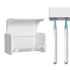 two electric toothbrushes are attached to the wall next to an electrical outlet and holder