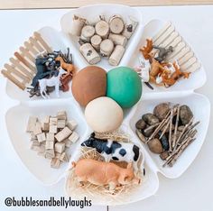 a white tray topped with lots of different types of toys and animals on top of it