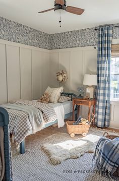 a bedroom with two twin beds and blue curtains