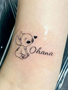 a small tattoo on the leg of a woman with an elephant and heart in it