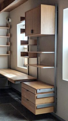 an empty room with shelves and drawers on the wall