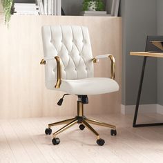 a white office chair sitting on top of a hard wood floor next to a desk