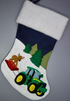 a christmas stocking with a tractor and deer on it