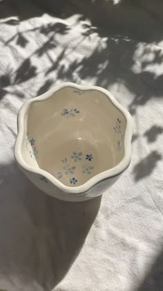 a white bowl with blue flowers on it