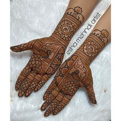 two hands with henna designs on them