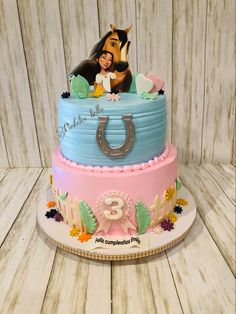 a birthday cake with a horse on top and the number three is decorated in fondant