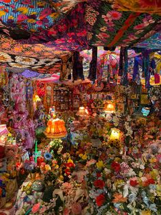 a room filled with lots of colorful items and lights hanging from the ceiling above it