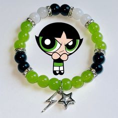 the powerpuff girl bracelet has been made with green glass beads and silver charms