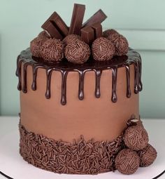 a chocolate cake with chocolate candies on top and drizzled in chocolate