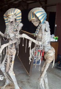 two skeletons dressed in costumes standing next to each other