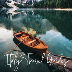 a wooden boat sitting on top of a lake