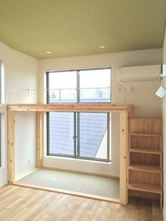 an empty room with wooden floors and windows