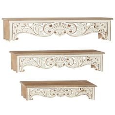 two white wooden shelves with carvings on them